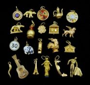 Twenty one 18ct gold charms including guitar
