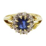 Gold oval sapphire and diamond cluster ring