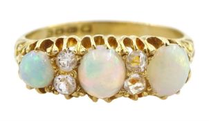 Edwardian three stone opal and four clear stone ring