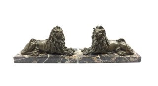 Pair of Victorian bronze figures of recumbent lions on marble plinths