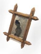 Small Tramp art wall mirror in geometrically carved stained pine frame
