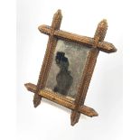 Small Tramp art wall mirror in geometrically carved stained pine frame