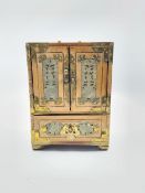 Oriental jewellery chest fitted with small drawers and enclosed by mother of pearl decorated doors a