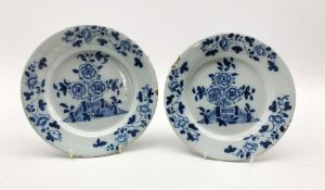 Pair of 18th century Delft tin-glazed plates decorated with a fence and flowers