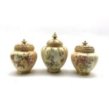 Pair of Royal Worcester pot pourris and covers decorated with floral sprays on a blush ivory ground