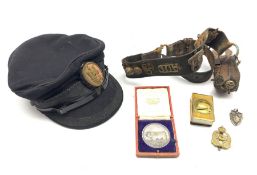 Leather belt hung with various military cap badges including 78th Winnipeg Grenadiers