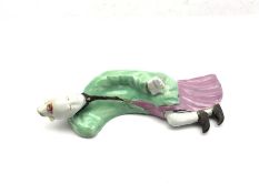 Chinese Qianlong figure of a reclining lady holding a book in one hand decorated in green and purple