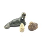 20th century Inuit soapstone carving of a Walrus with bone tusks