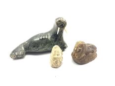 20th century Inuit soapstone carving of a Walrus with bone tusks