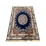 Traditional Middle Eastern design blue ground rug centred by a floral medallion