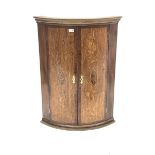 Early 20th century oak and mahogany banded bow front corner cupboard