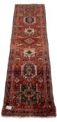 Persian karajeh red ground runner rug with repeating geometric medallions 70cm x 256cm