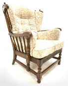 Ercol 'cloister' stained elm wingback armchair