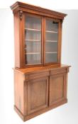 Victorian mahogany bookcase on cupboard