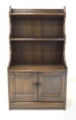 Ercol dark elm open waterfall bookcase on cupboard