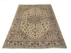 Persian fine Kashan ivory ground carpet centred by a floral medallion 292cm x 390cm