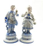 Pair of German bisque figures of a dandy and his lady highlighted with glazed and coloured decoratio