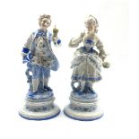 Pair of German bisque figures of a dandy and his lady highlighted with glazed and coloured decoratio