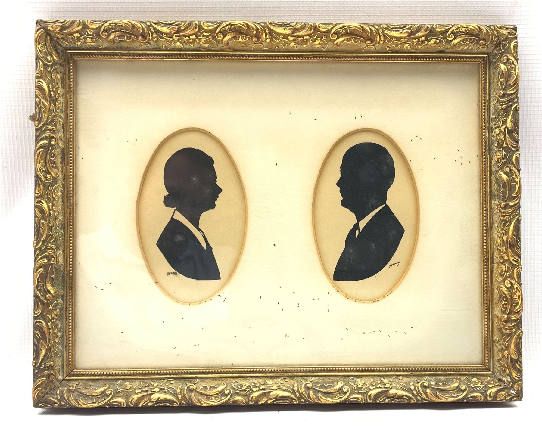Harry Laurence Oakley (1882-1960) Pair of half length oval silhouette male and female portraits