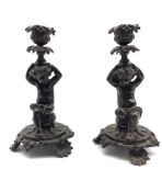 Pair of patinated bronze figural candlesticks