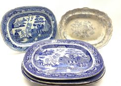 Four 19th century blue and white transfer printed meat plates decorated in the Willow pattern