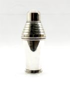 Art Deco electroplated cocktail shaker with stepped ribbed upper section and circular foot by Fairfa