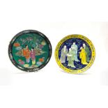 Japanese plate decorated with figures within a yellow floral border and another similar in black fl