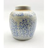 Chinese provincial jar and cover decorated in blue and white with trailing leaves H22cm