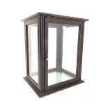 Early 20th century mahogany glazed counter top display cabinet of rectangular form upon a stepped pl