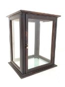 Early 20th century mahogany glazed counter top display cabinet of rectangular form upon a stepped pl