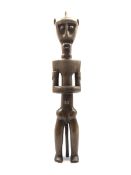 Fang carved hardwood ancestor figure formed as a standing male H66cm