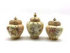 Pair of Royal Worcester pot pourris and covers decorated with floral sprays on a blush ivory ground