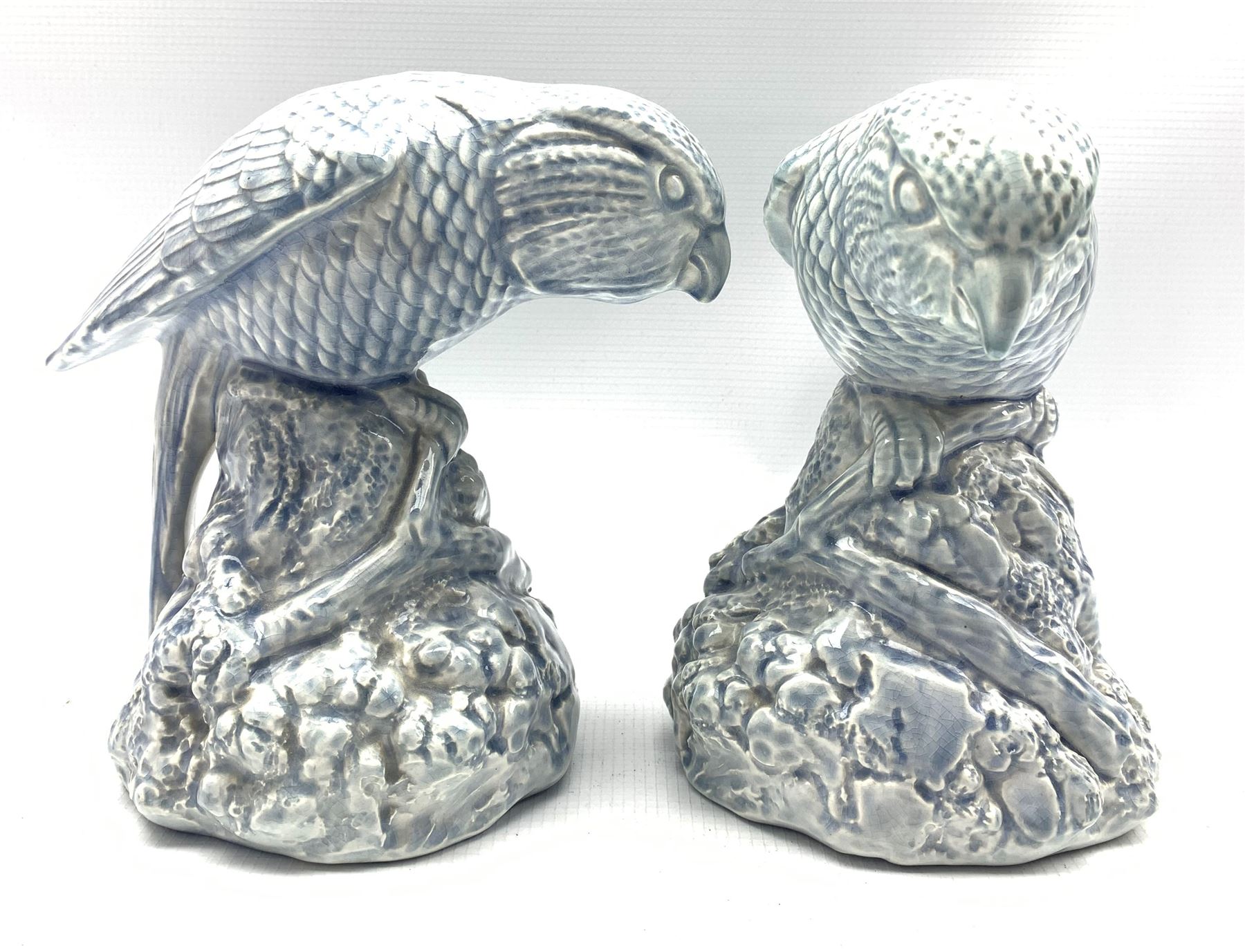 Pair of Bretby figures of parrots in a pale blue glaze H19cm