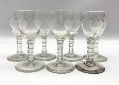 Seven 19th century cordial glasses decorated with trailing garlands on facet cut stems H13cm