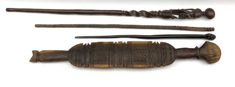 Tribal paddle club with carved and incised decorationL86cm and three African sticks