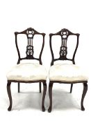 Pair Edwardian carved walnut framed bedroom chairs with cream damask seats and slender supports W45c
