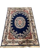 Traditional Middle Eastern design blue ground rug centred by a floral medallion