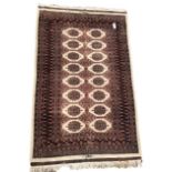 Persian design Bokhara ground rug with repeating gul and lozenge design 195cm x 125cm