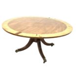 Regency crossbanded mahogany circular tilt top dining table on quartette splay supports with brass c