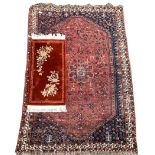 Hamadan rug of stylised floral design on a red field and bordered