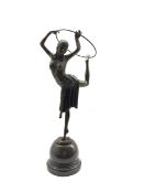 Art Deco style bronze figure of a dancer standing on one leg with a hoop above her head