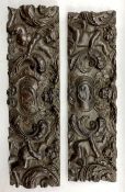 Pair of 17th Century oak panels carved with putti and foliage