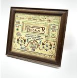 A needlework cross stitch sampler to commemorate Queen Victoria