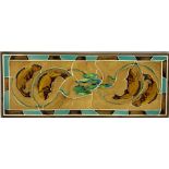 A set of framed tiles decorated with three stylized fish swimming amongst lily pads