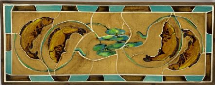 A set of framed tiles decorated with three stylized fish swimming amongst lily pads