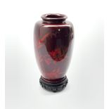 Oriental red lacquer vase decorated with bamboo and a bird on hardwood stand