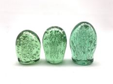 Victorian green glass dump paperweight of domed form with control bubble decoration