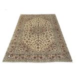 Persian fine Kashan ivory ground carpet centred by a floral medallion 292cm x 390cm