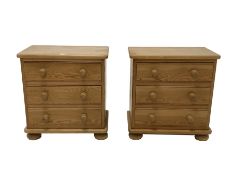 Pair solid pine three drawer bedside chests