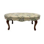 Upholstered oval footstool raised on walnut cabriole supports 116cm x 63cm